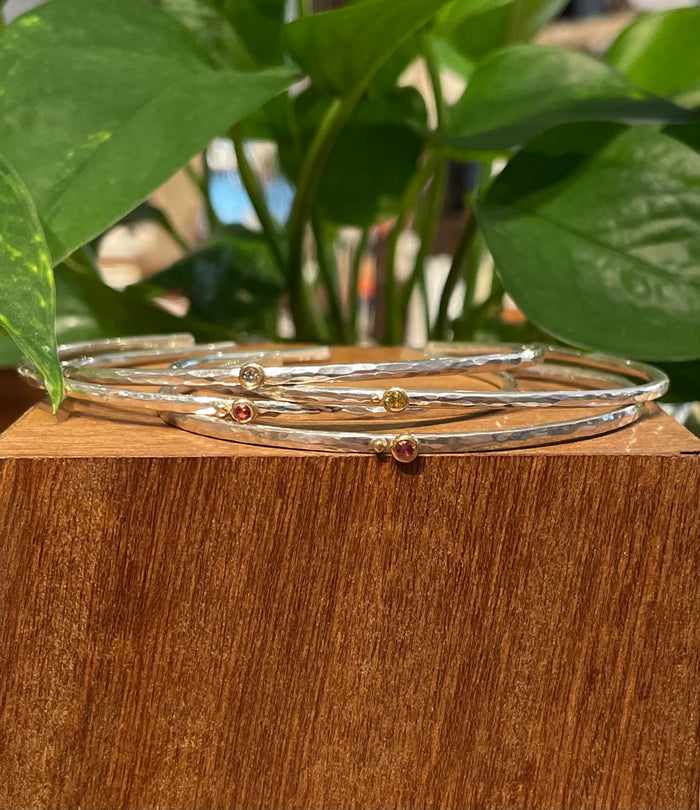 thin open bangle w/ a tiny diamond