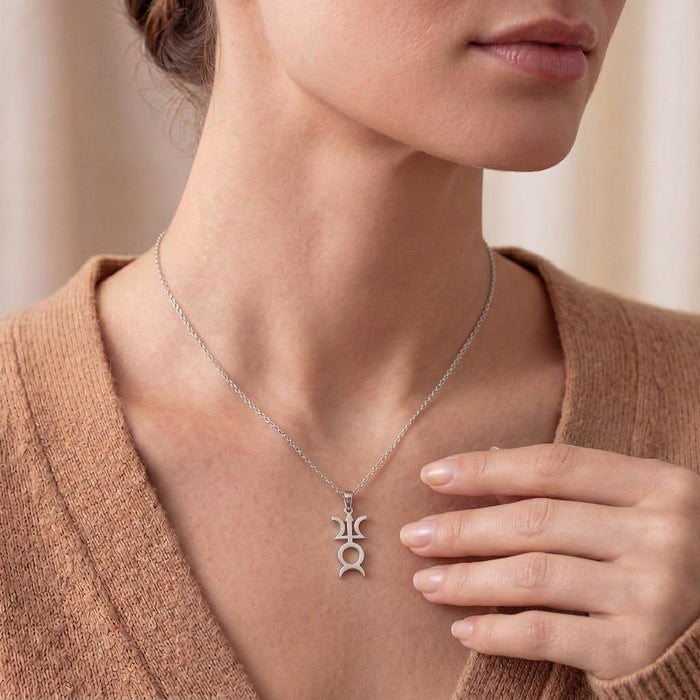 Close neckline view of a model wearing a silver Varuna Symbol Necklace