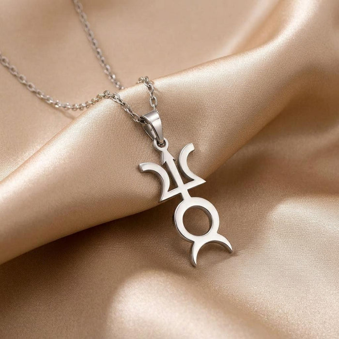 Angled close-up of a silver Varuna symbol pendant on champagne satin
