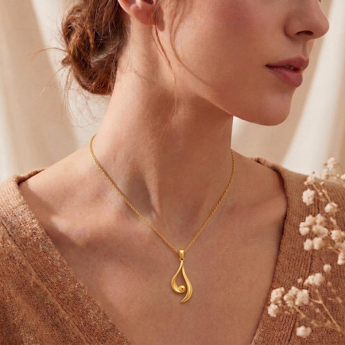 Gold Plated Silver Asymmetrical Aura Pendant worn at the collarbone with a V-neck top
