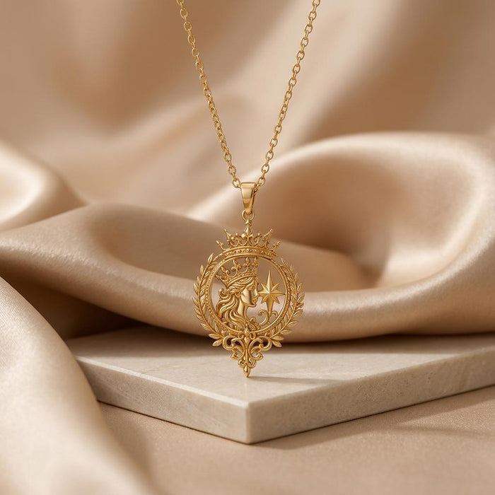 Gold-finish Celestial Queen Emblem Pendant with crowned portrait and star displayed above a stone block and champagne satin