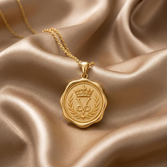 Gold Plated Silver Crown Seal Pendant Necklace with crowned emblem and laurel branches on champagne satin