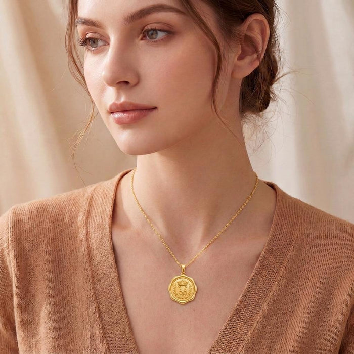 Model wearing a Gold Plated Silver Crown Seal Pendant Necklace with a scalloped seal-shaped pendant
