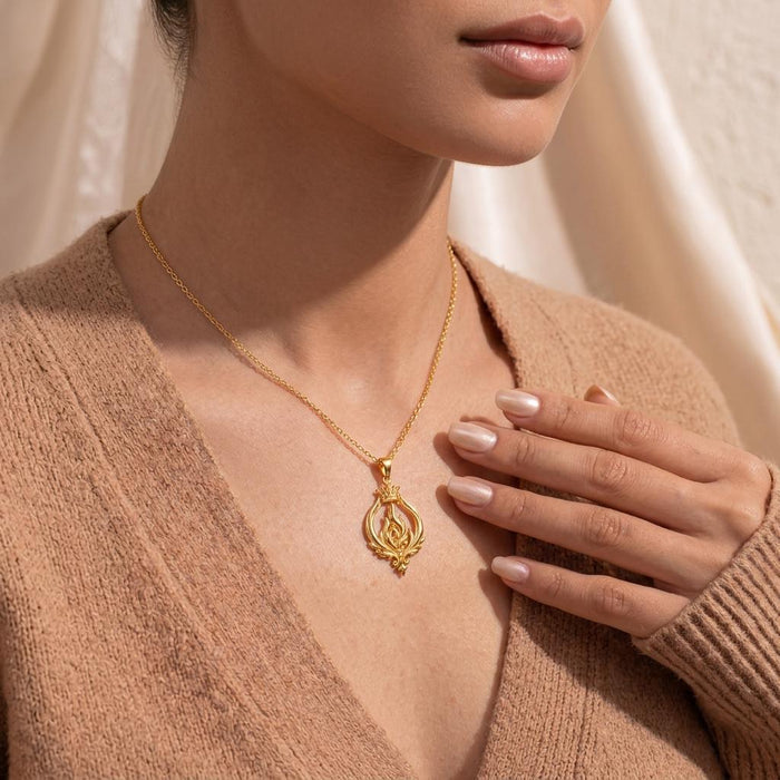 Model wearing the Gold Plated Silver Empress Flame Crest Necklace with a textured neutral sweater