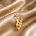 Gold Plated Silver Griffin Wing Pendant Necklace with side-facing griffin and layered wing on champagne satin