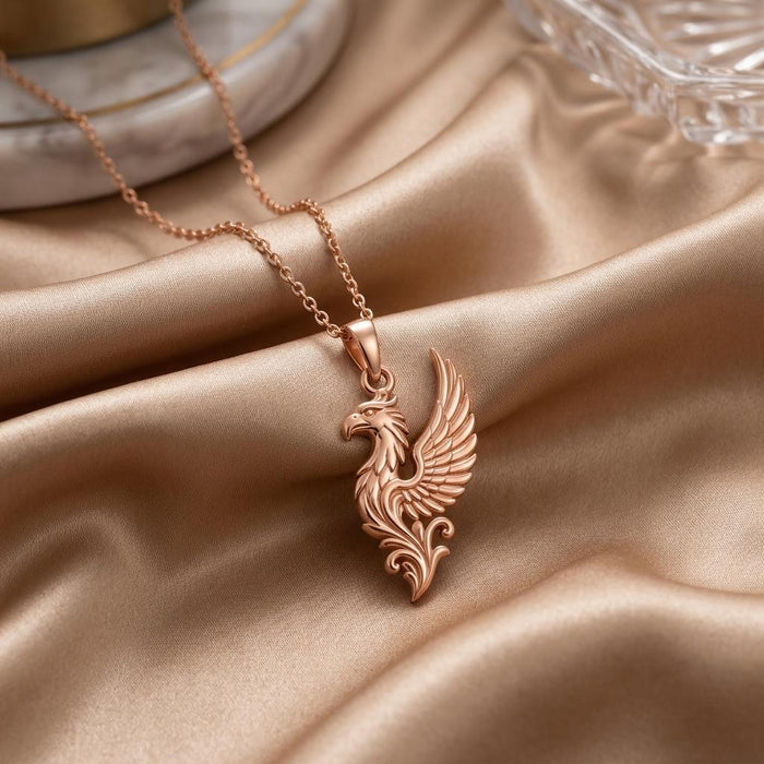 Rose Gold Plated Griffin Wing Pendant Necklace with layered feather detail on champagne satin