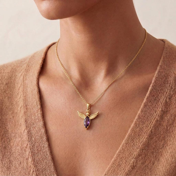 Close view of a woman wearing the Angel Wing Necklace with a neutral V-neck sweater