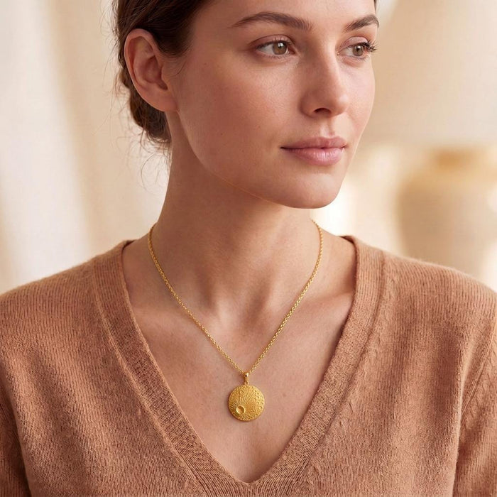 Gold Plated Silver Lunar Impact Pendant worn on a model with a V-neck knit top