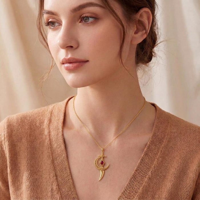 Moonblade pendant necklace worn with a Gold Plated Silver chain over a V-neck knit top