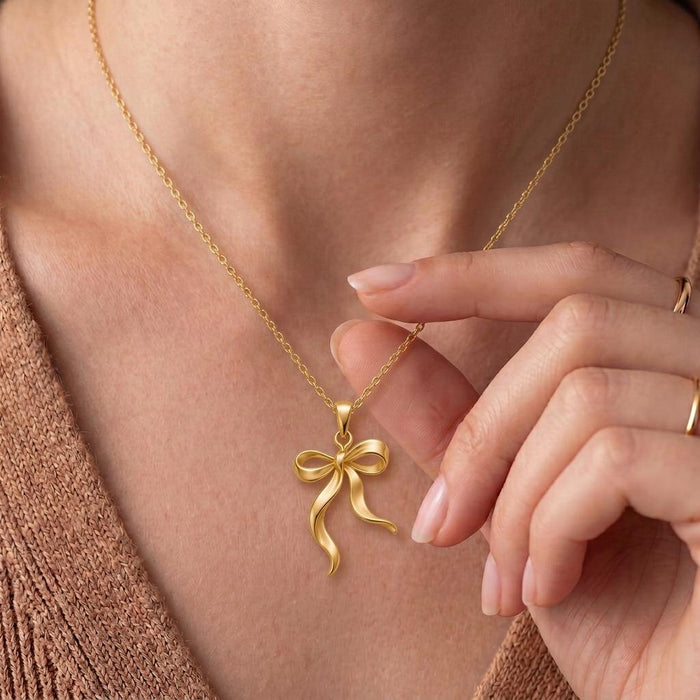 Gold Plated Silver Ribbon Flow Necklace worn with a textured knit top