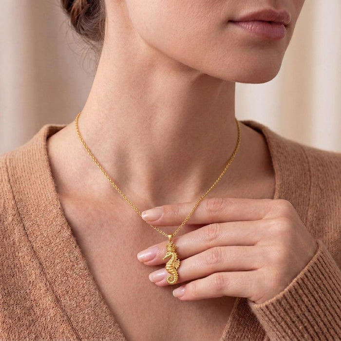 Gold Plated Silver Seahorse Crown Necklace worn at the collarbone with a neutral knit top