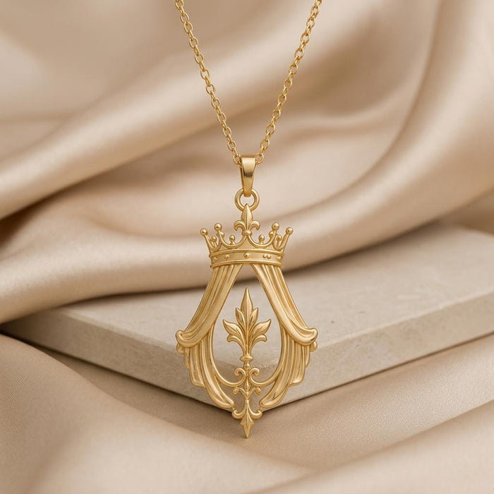 Imperial Crown Veil Necklace with crown, drapery-inspired openwork, and fleur-de-lis center displayed on a pale stone block