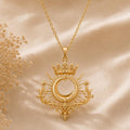 Gold Plated Silver Royal Eclipse Tiara Pendant with crowned crescent and radiant rays on champagne satin