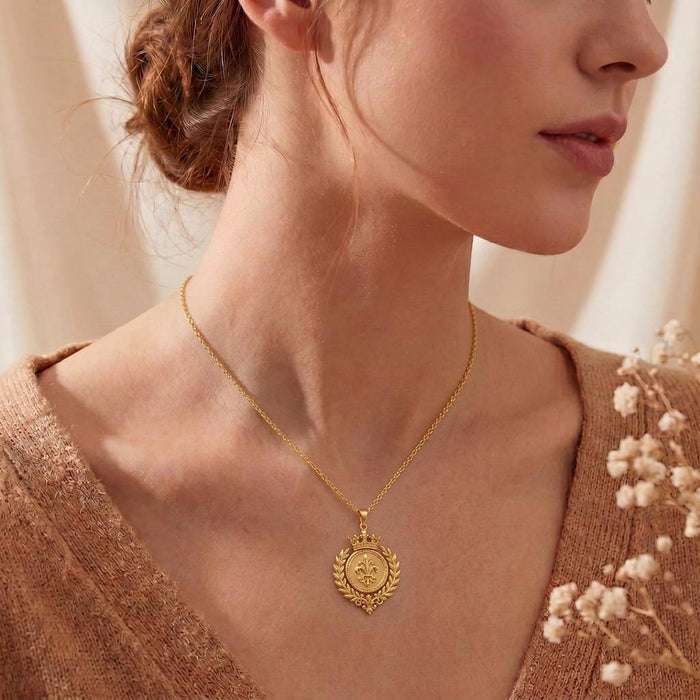 Side-profile view of a woman wearing the Gold Plated Silver Royal Laurel Sigil Pendant with a brown knit top