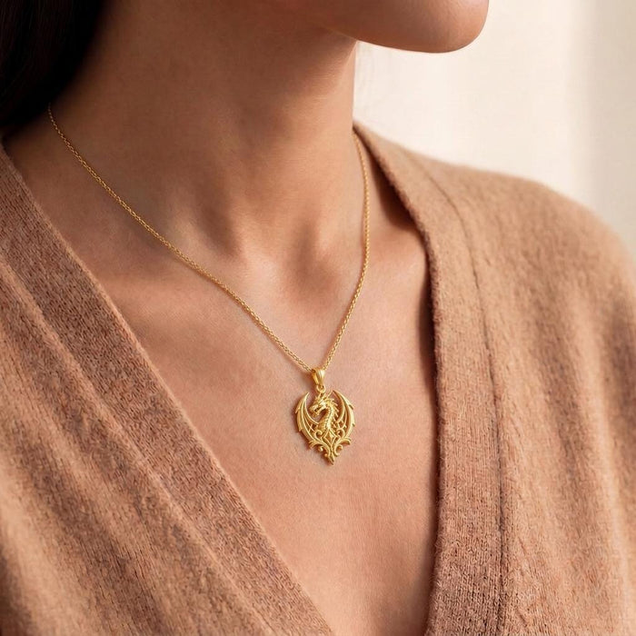 Close-up of Gold Plated Silver Dragon Crest Pendant worn with a knit cardigan