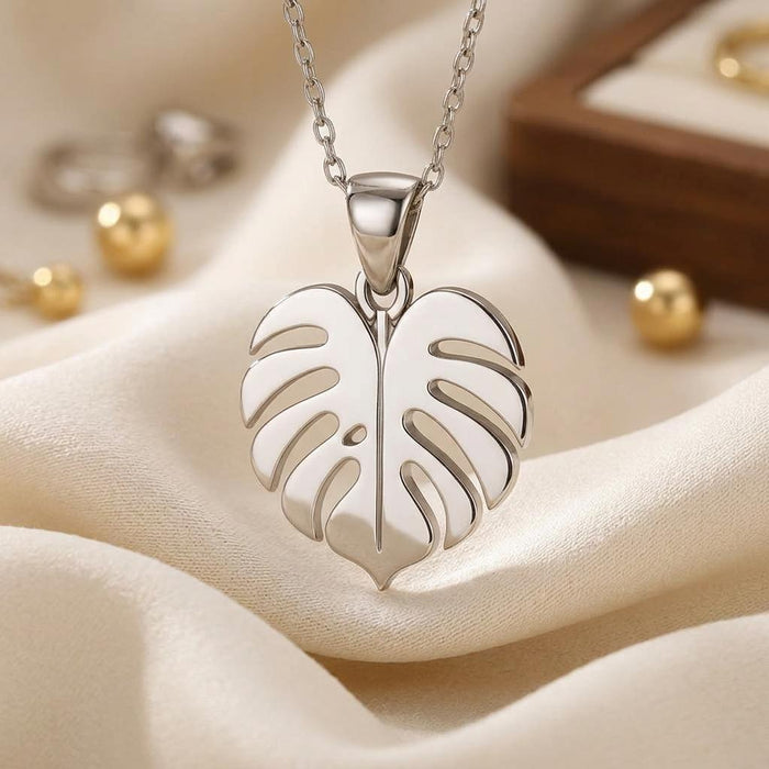 Macro product view of the solid center vein and curved leaf cutouts on ivory fabric