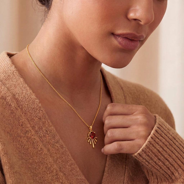 Close view of a model wearing a Gold Plated Silver Sun Drop Pendant Necklace with radiating rays