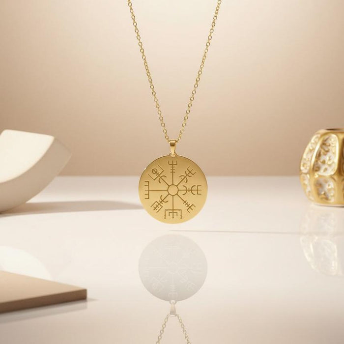 Gold Plated Silver Vegvisir Compass Necklace suspended above a reflective neutral display surface